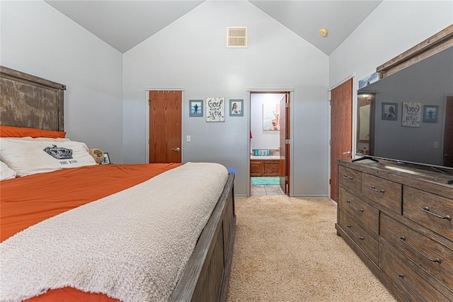 bedroom with visible vents, light colored carpet, high vaulted ceiling, and connected bathroom