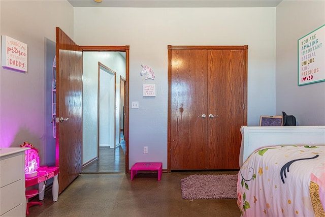 bedroom featuring a closet and concrete floors