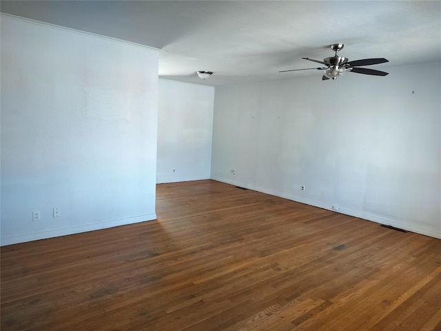 unfurnished room featuring baseboards, ceiling fan, and wood finished floors