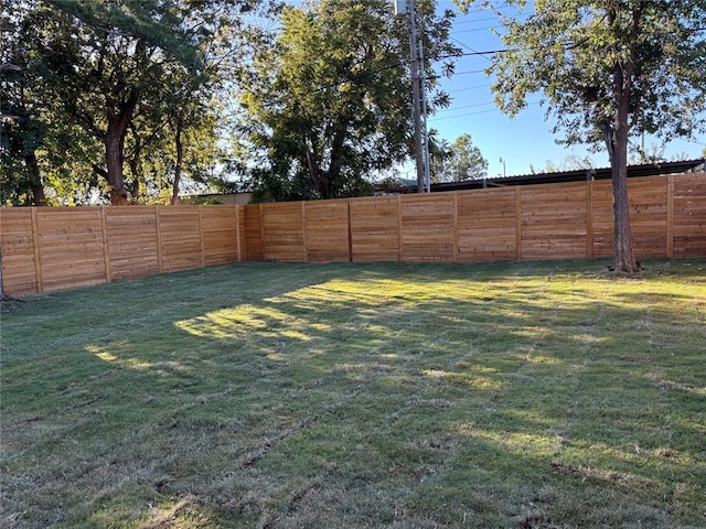 view of yard with a fenced backyard