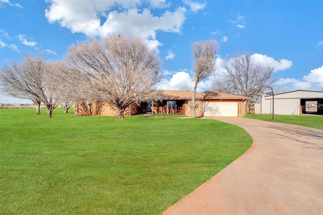 ranch-style home featuring an attached garage, concrete driveway, and a front lawn