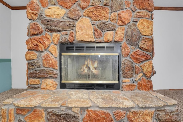 details featuring a stone fireplace and crown molding