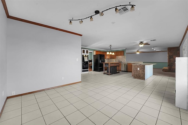 unfurnished living room with crown molding, light tile patterned floors, ceiling fan with notable chandelier, and visible vents