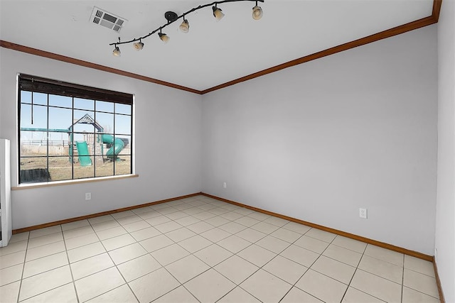 empty room with visible vents, baseboards, and ornamental molding