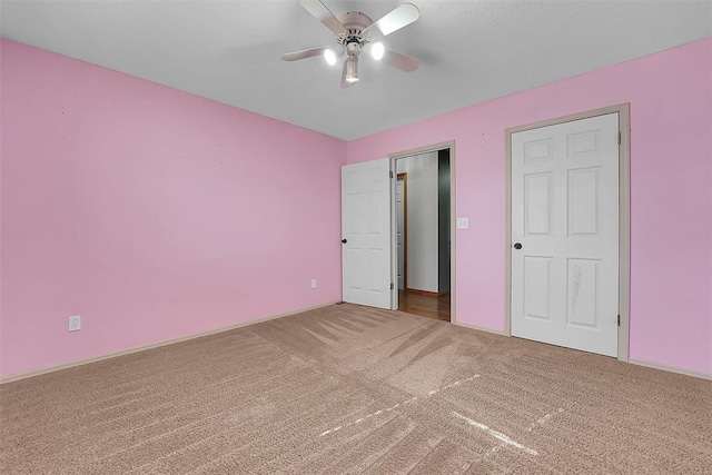 unfurnished bedroom with carpet floors and ceiling fan