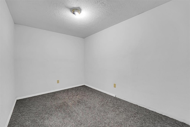 unfurnished room with baseboards, carpet, and a textured ceiling