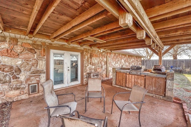 view of patio featuring grilling area and fence