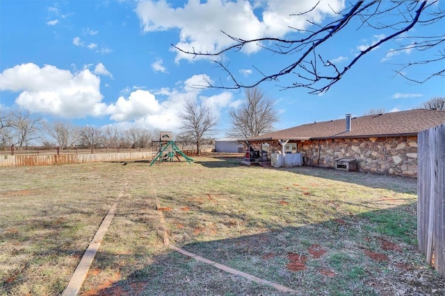 view of yard featuring a playground and fence