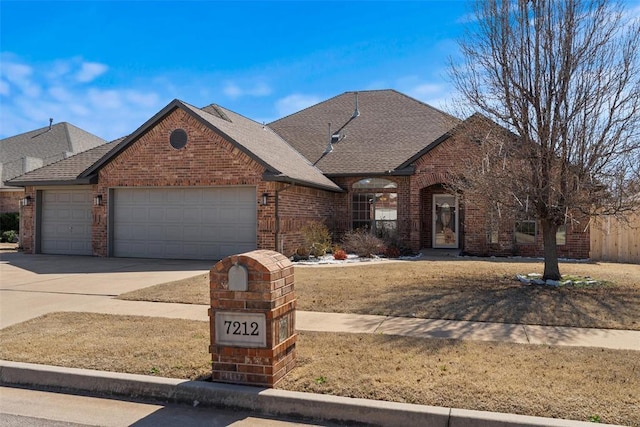 view of front facade with an attached garage, brick siding, driveway, and roof with shingles