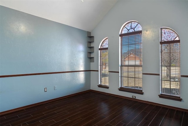 spare room with lofted ceiling and wood finished floors