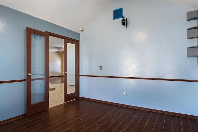 spare room featuring french doors, visible vents, and wood tiled floor