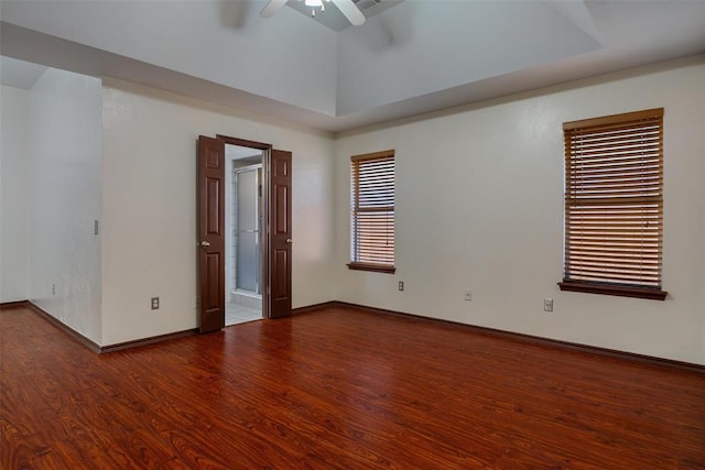 empty room featuring baseboards, ceiling fan, and wood finished floors