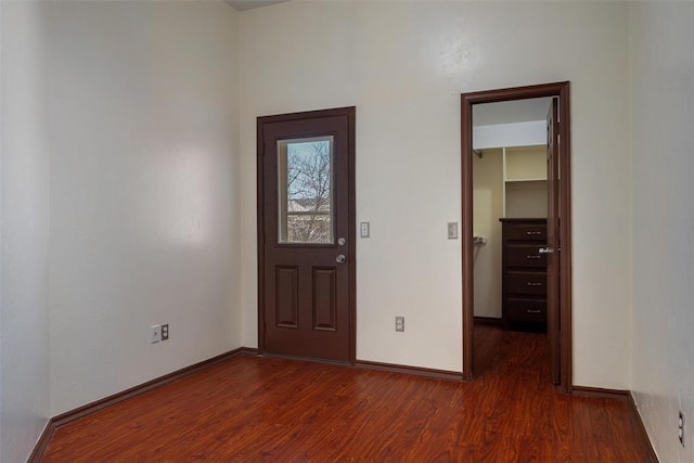 foyer entrance featuring wood finished floors and baseboards