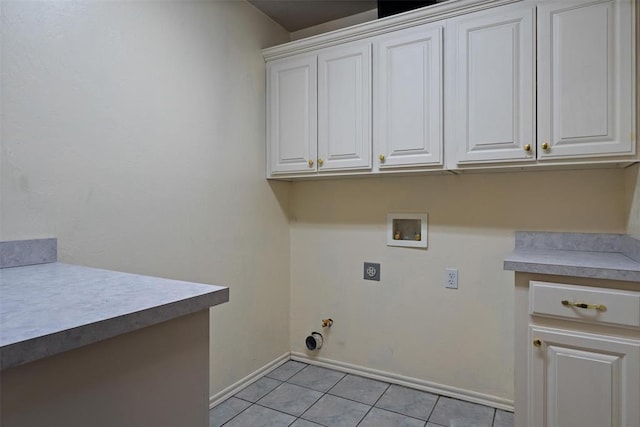 washroom featuring washer hookup, hookup for a gas dryer, light tile patterned flooring, cabinet space, and electric dryer hookup