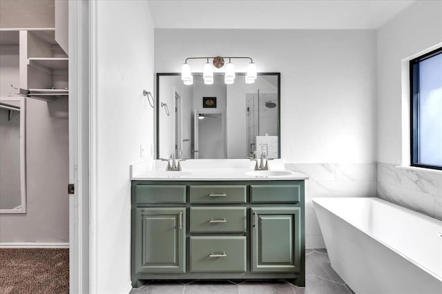 bathroom with a sink, a freestanding bath, walk in shower, and double vanity