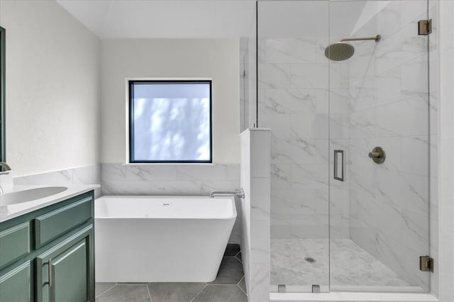 bathroom featuring vanity, a marble finish shower, a soaking tub, tile patterned floors, and tile walls