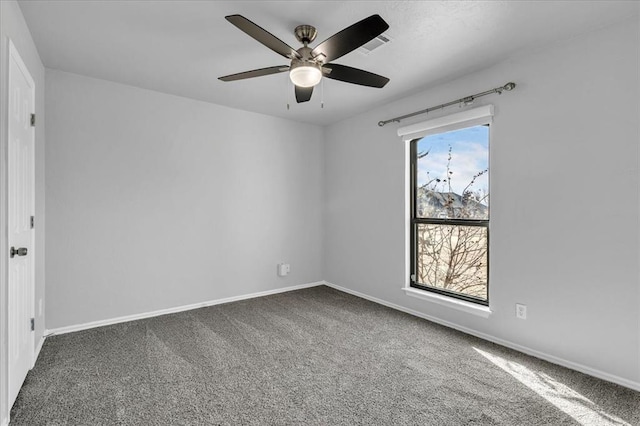 spare room with visible vents, baseboards, a ceiling fan, and carpet flooring