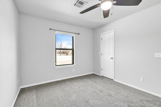 spare room with baseboards, visible vents, carpet floors, and ceiling fan