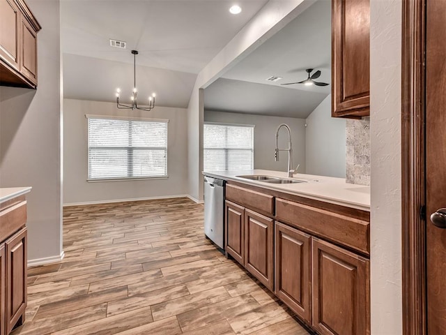 kitchen with lofted ceiling, light wood-style flooring, a sink, dishwasher, and ceiling fan with notable chandelier