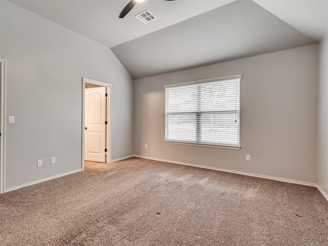 carpeted spare room with a ceiling fan, vaulted ceiling, baseboards, and visible vents