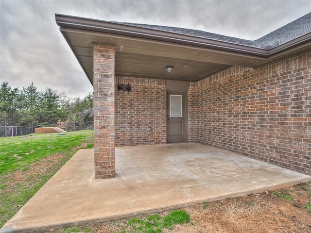 view of patio / terrace featuring an attached carport and fence