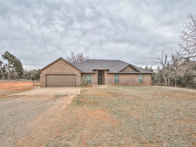 view of front facade with concrete driveway, an attached garage, brick siding, and roof with shingles