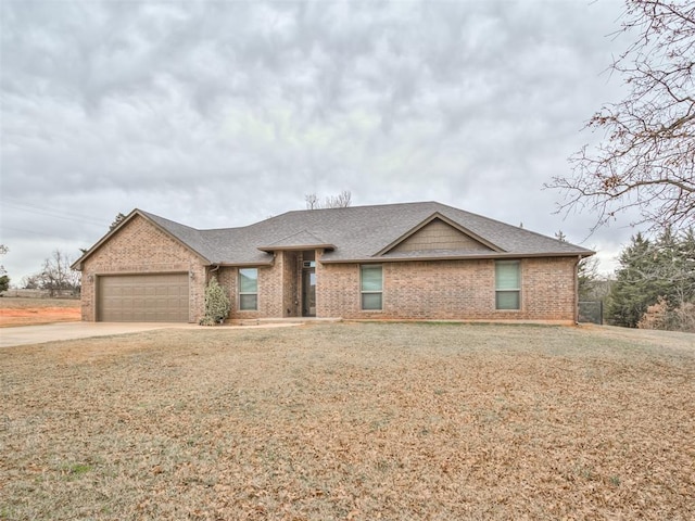 view of front of home with brick siding, a shingled roof, a front lawn, concrete driveway, and a garage