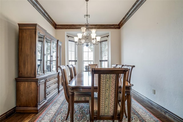 dining area with visible vents, baseboards, ornamental molding, an inviting chandelier, and dark wood-style flooring