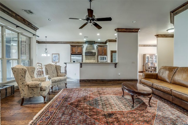 living area featuring dark wood-style floors, recessed lighting, a healthy amount of sunlight, and visible vents