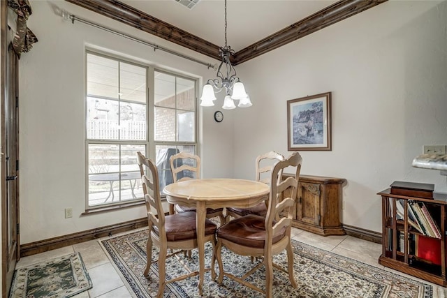 dining area with light tile patterned floors, baseboards, a chandelier, and crown molding