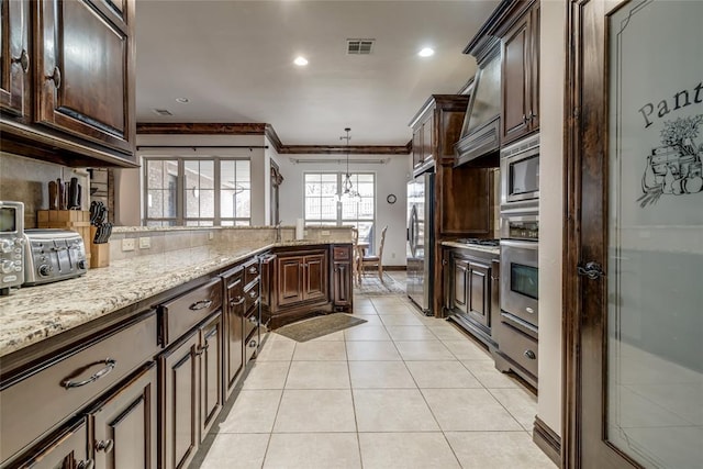 kitchen with visible vents, light stone counters, appliances with stainless steel finishes, crown molding, and light tile patterned floors