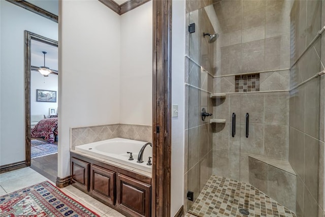 ensuite bathroom featuring tile patterned flooring, a shower stall, a bath, and ensuite bathroom