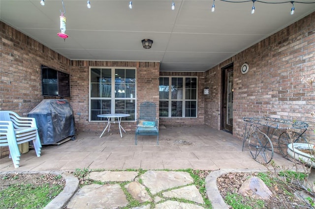 view of patio featuring a grill