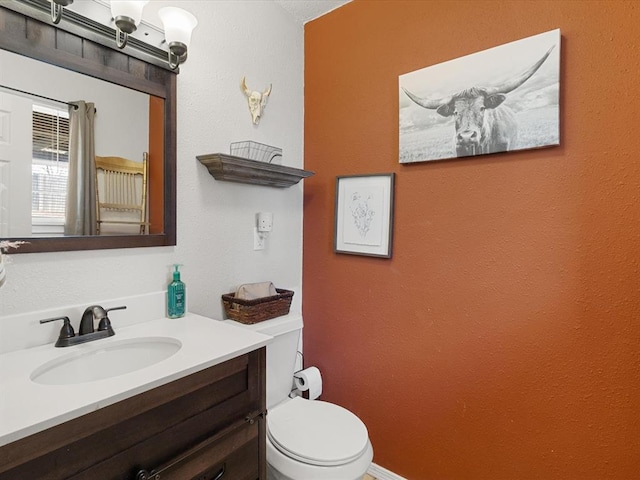 half bathroom with toilet and vanity