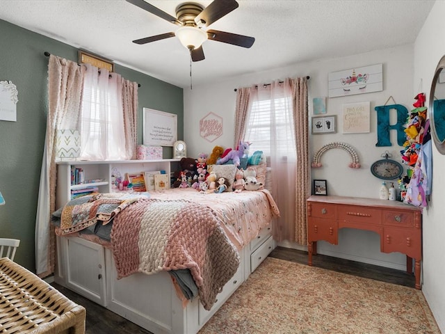 bedroom featuring ceiling fan, a textured ceiling, and wood finished floors