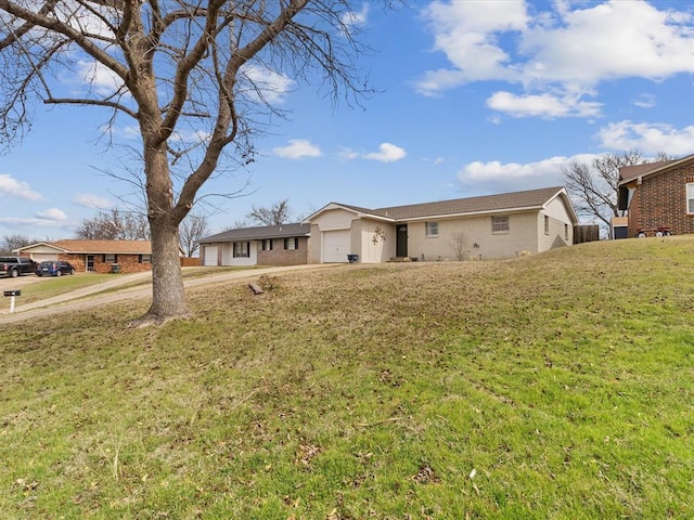 rear view of property with a lawn and an attached garage