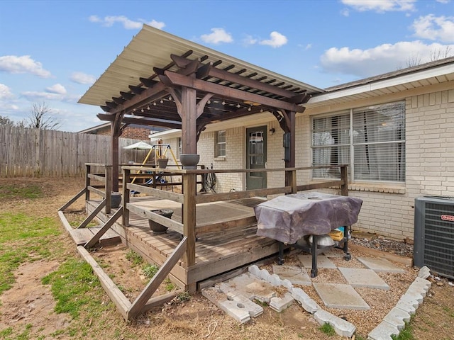 wooden deck featuring central AC unit, a pergola, and fence