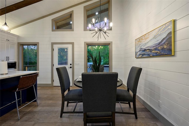 dining room featuring baseboards, vaulted ceiling with beams, an inviting chandelier, and dark wood-style flooring