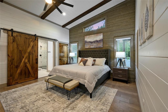 bedroom featuring wooden walls, wood finished floors, high vaulted ceiling, a barn door, and beamed ceiling