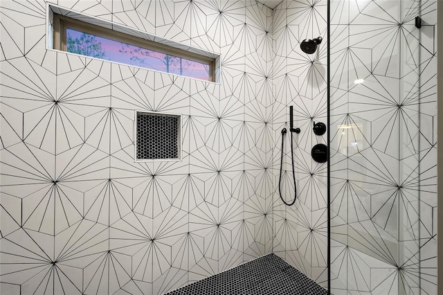 interior details featuring a tile shower