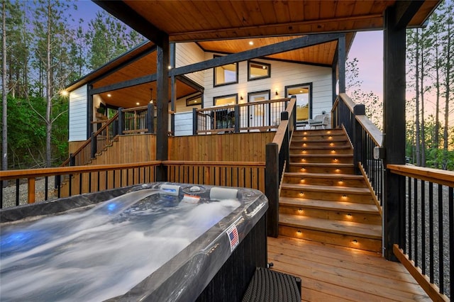 deck with stairs and a hot tub