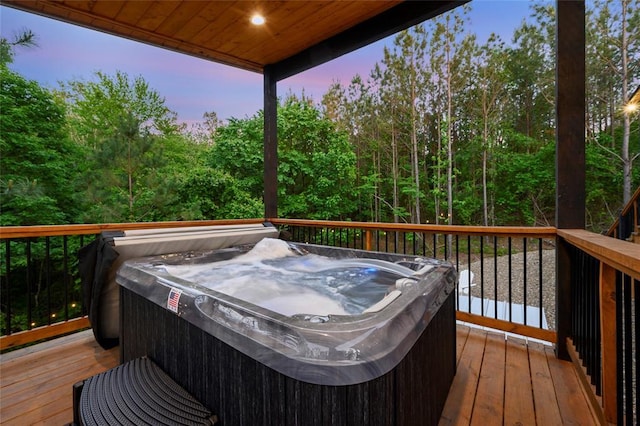 wooden deck featuring a hot tub