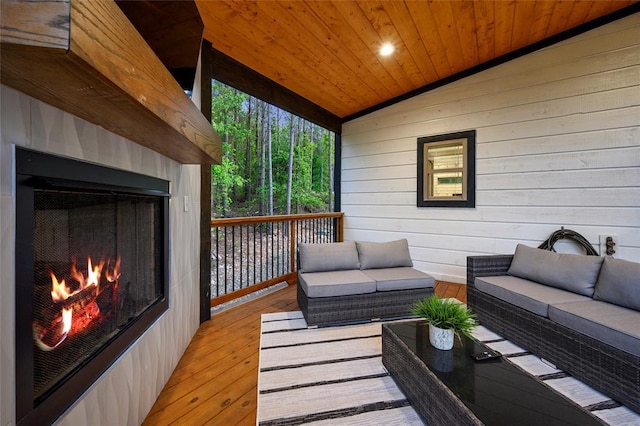 wooden deck featuring an outdoor living space with a fireplace