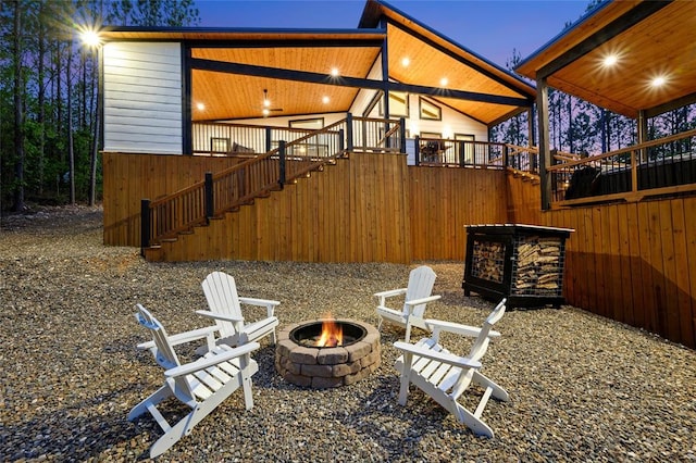 view of patio featuring stairs and a fire pit