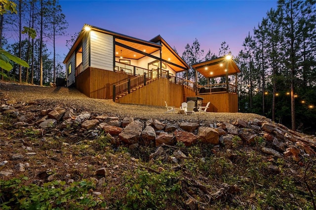 view of property exterior with a deck and stairs