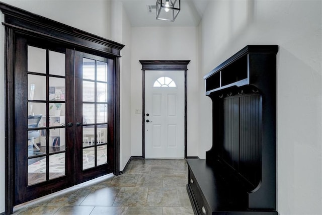 mudroom featuring french doors and baseboards