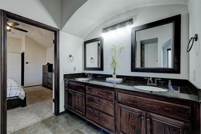 bathroom featuring a sink, lofted ceiling, a ceiling fan, and double vanity