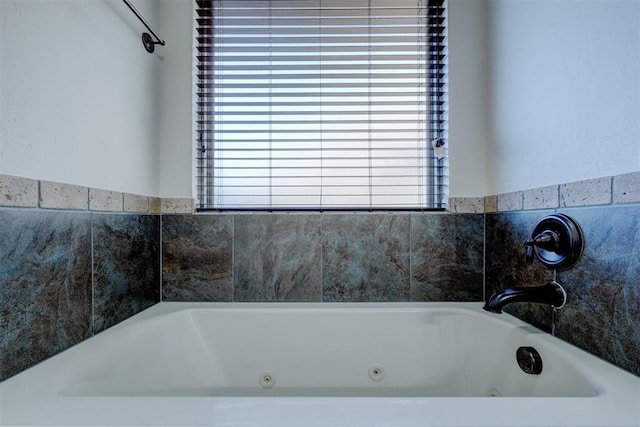 full bathroom with a whirlpool tub