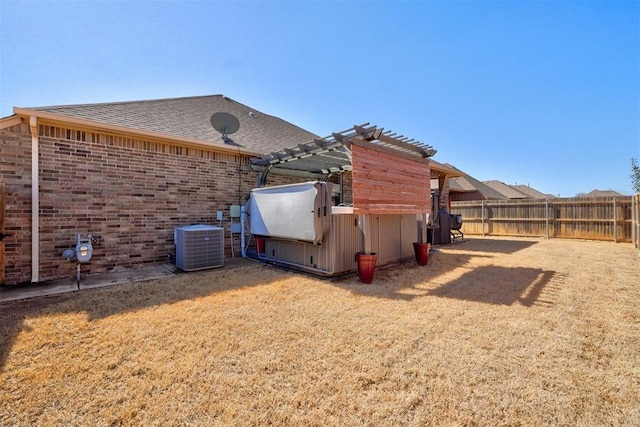 view of side of home featuring a pergola, central AC, fence, roof with shingles, and brick siding