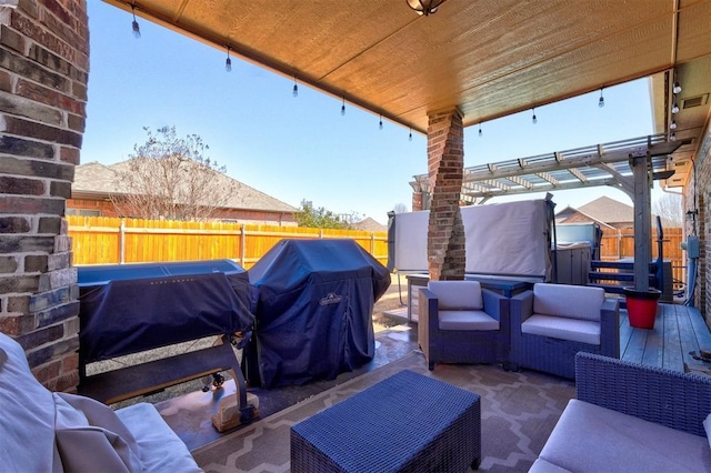 view of patio with grilling area, an outdoor hangout area, a pergola, and a fenced backyard